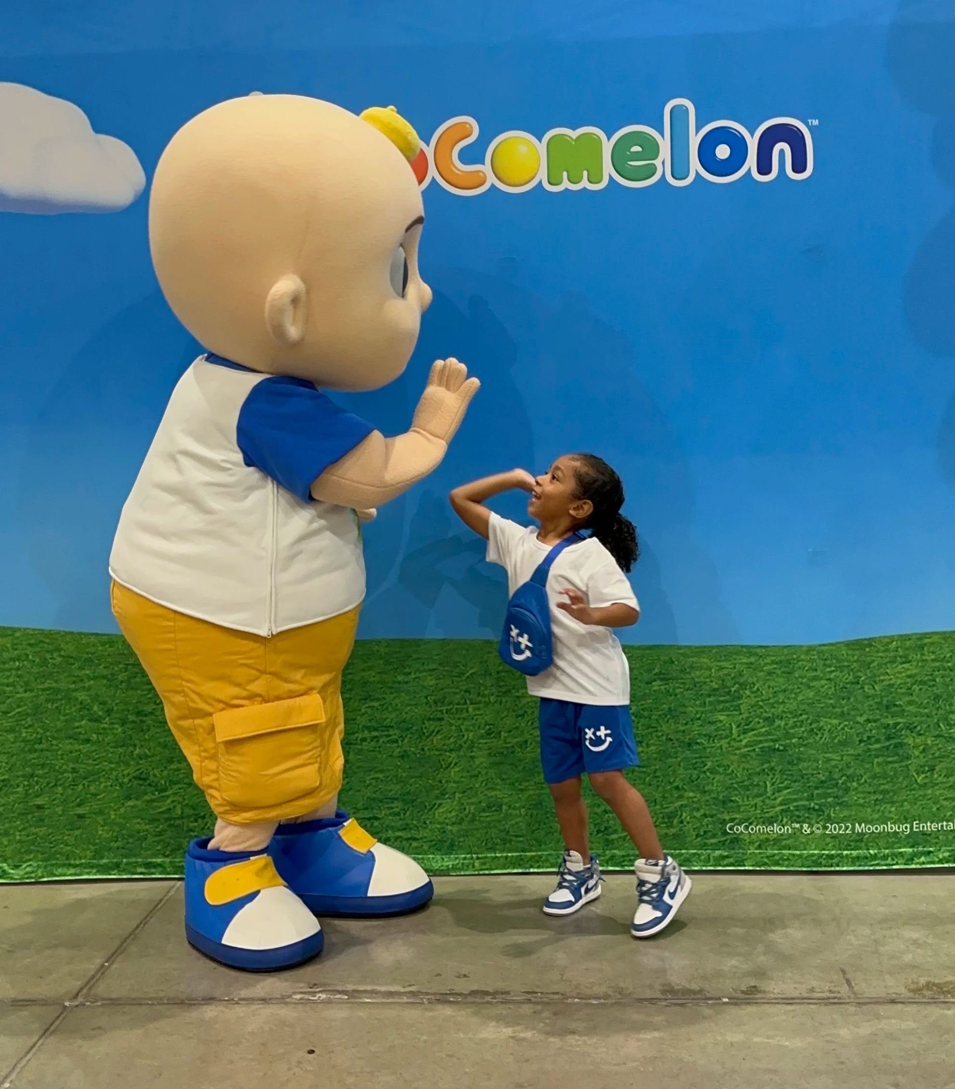 JJ from CoComelon high fiving a little fan